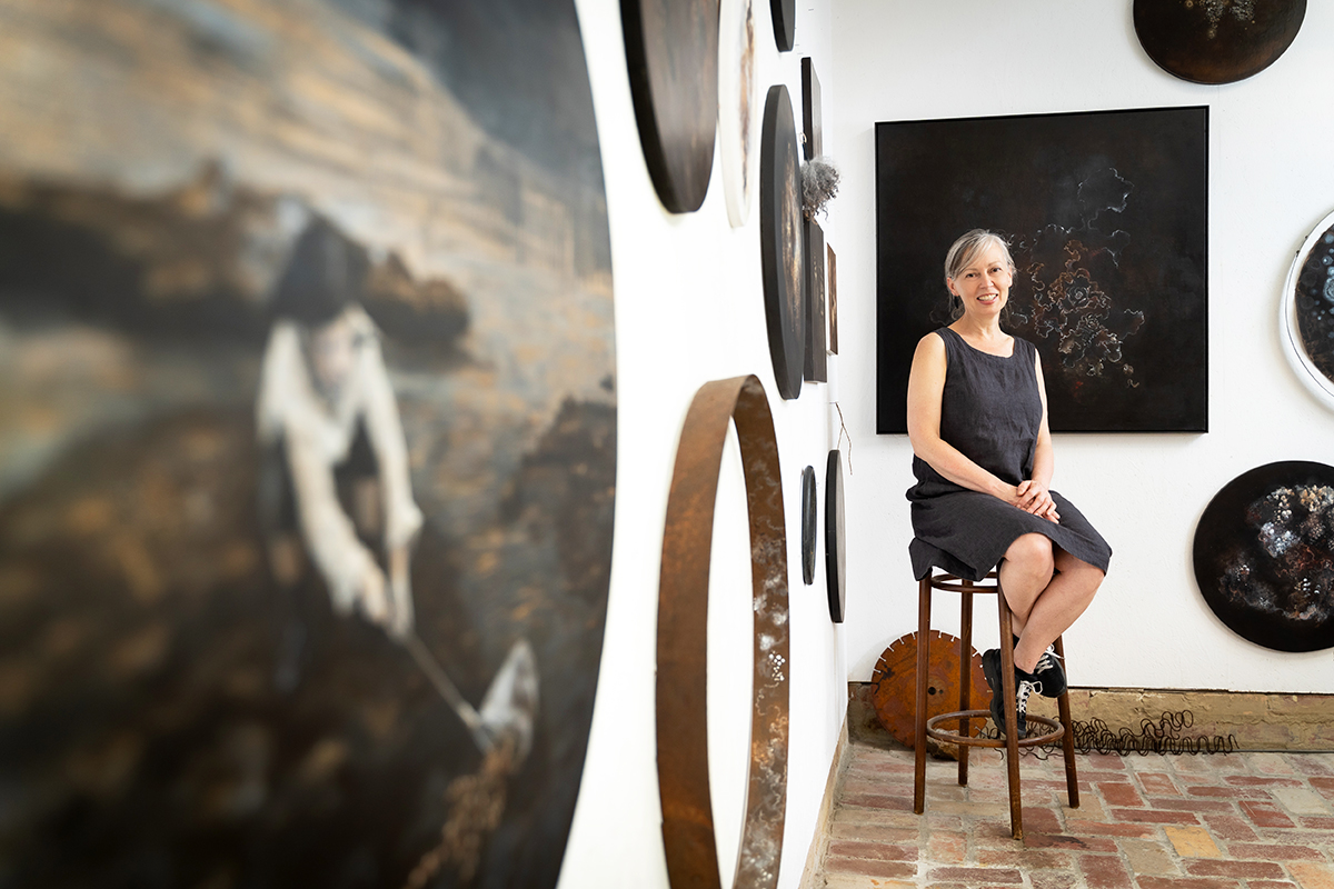 Penelope Aitken sits in her studio