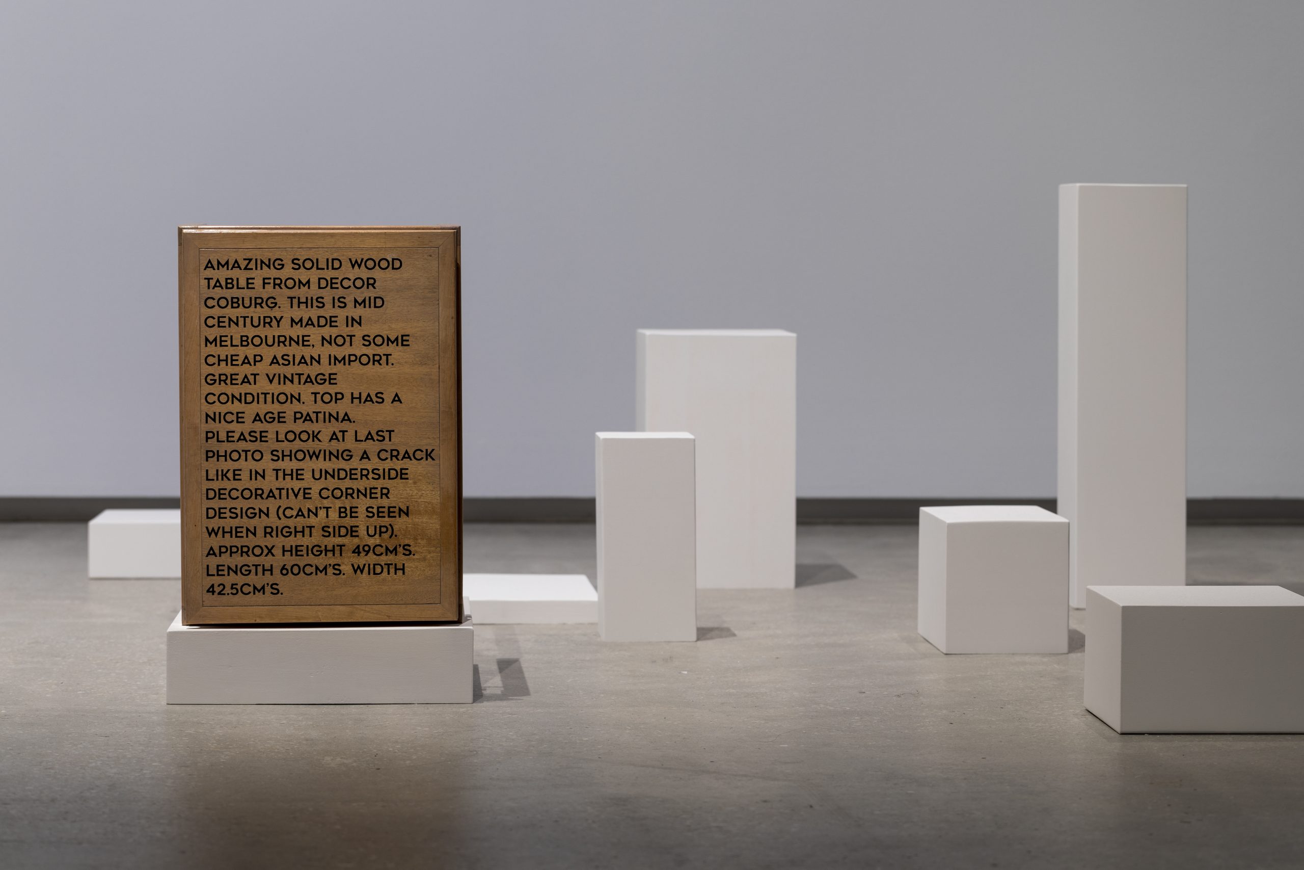an artwork installation of furniture reconstructed as plinths in a gallery