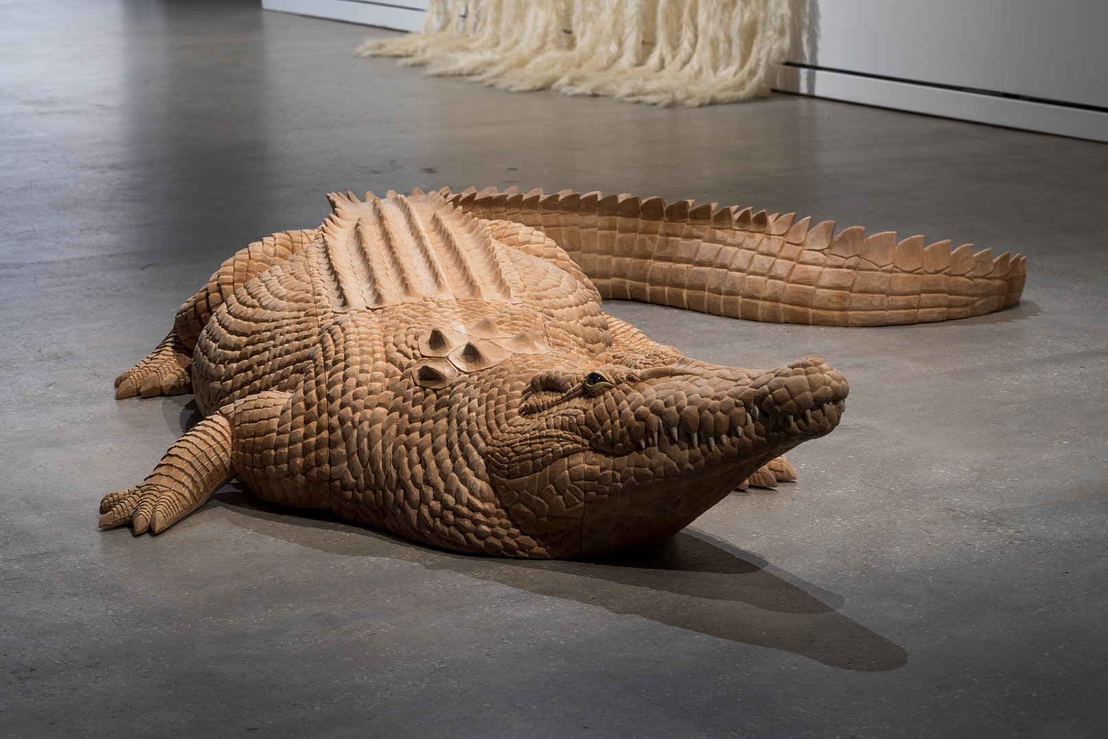 a wooden crocodile sculpture